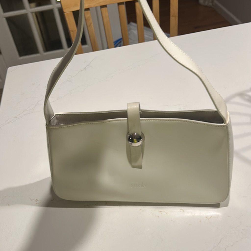 Pale sage green Furla baguette bag with a rectangular body, flap closure and short shoulder strap
